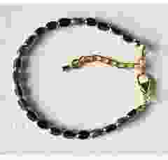 Bracelet 5x3mm black and gold facetted beads