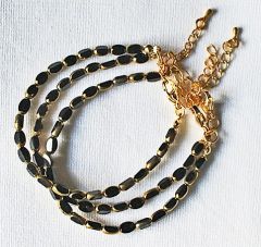 Armband zwarte kralen met goudkleurige rand