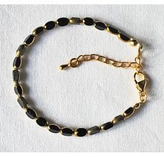 Bracelet 5x3mm black and gold facetted beads